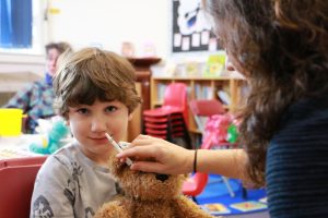 Young boy receiving nasal flu vaccine