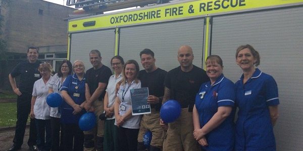 Staff take part in tug of war to raise awareness about dementia