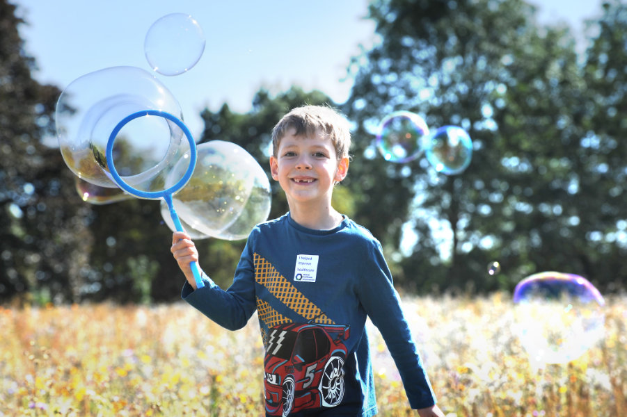 The Oxford Health Charity's Healthfest 2019 at The Warneford Hospital, Oxford. Six-year-old Norman having fun with bubbles in Warneford Meadow.