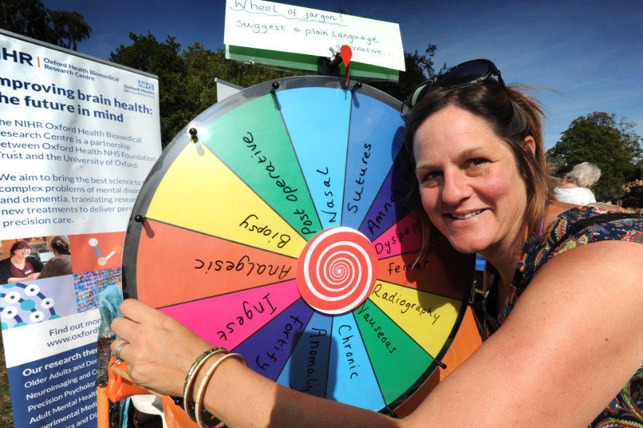 The Oxford Health Charity's Healthfest 2019 at The Warneford Hospital, Oxford. Patient and public involvement manager (research), Claire Murray, with her "Wheel of Jargon" for people to spin to land on a jargon word which they could suggest a layman's term for.