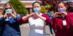 three people making heart signs